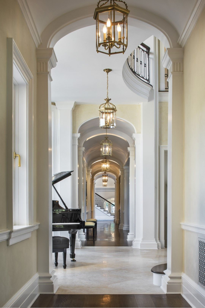 Classical Hallway Design with Red Carpet and Architectural Columns