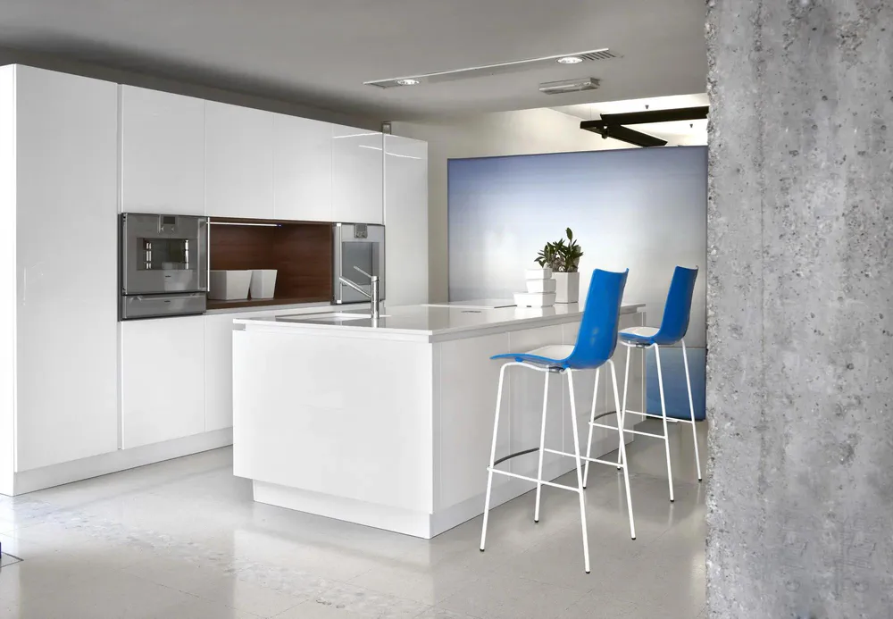 Modern Kitchen Design with High-Gloss Cabinetry and Concrete Walls