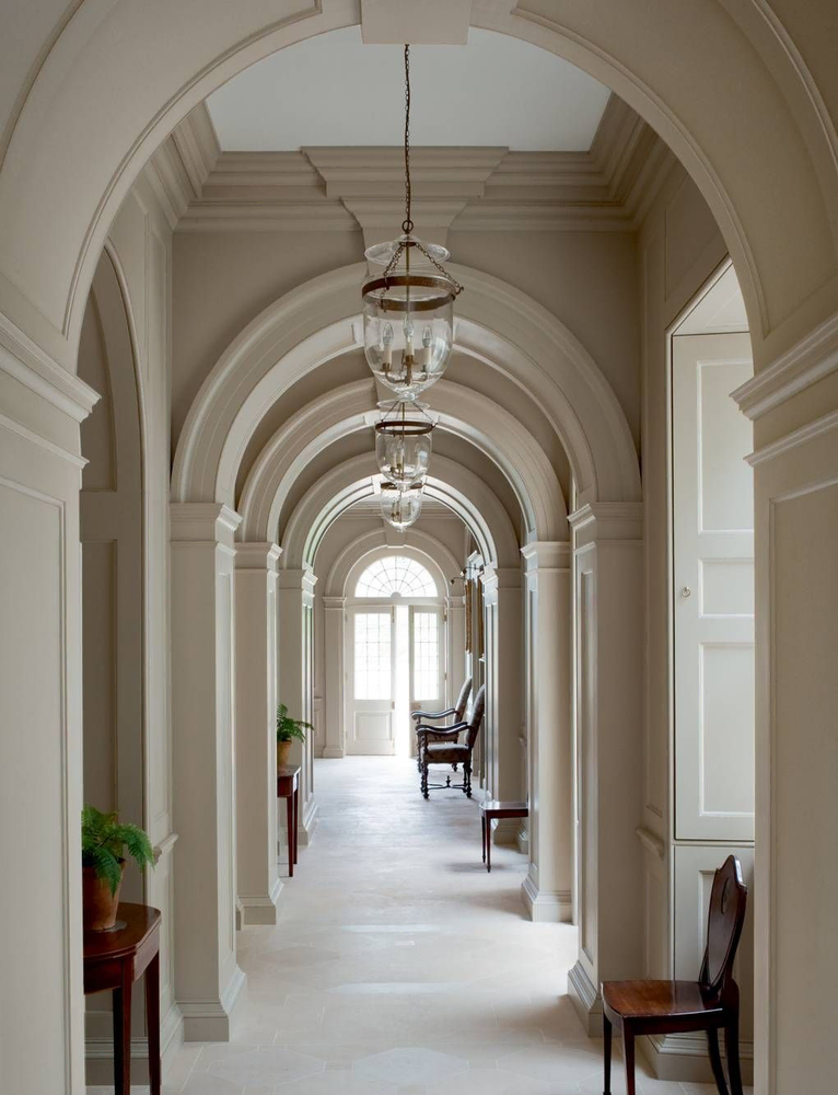 Classical Hallway Design with Red Carpet and Architectural Columns