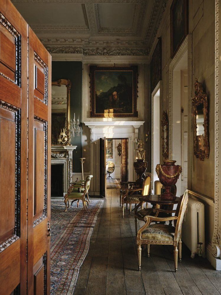 Classical Hallway Design with Red Carpet and Architectural Columns