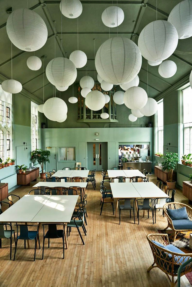 Modern Minimalist Restaurant Design with Green Walls and Paper Lanterns