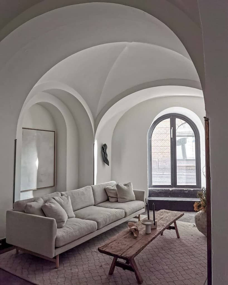 Modern Zen Minimalist Dining Room with Concrete Arch and Green Velvet Chair