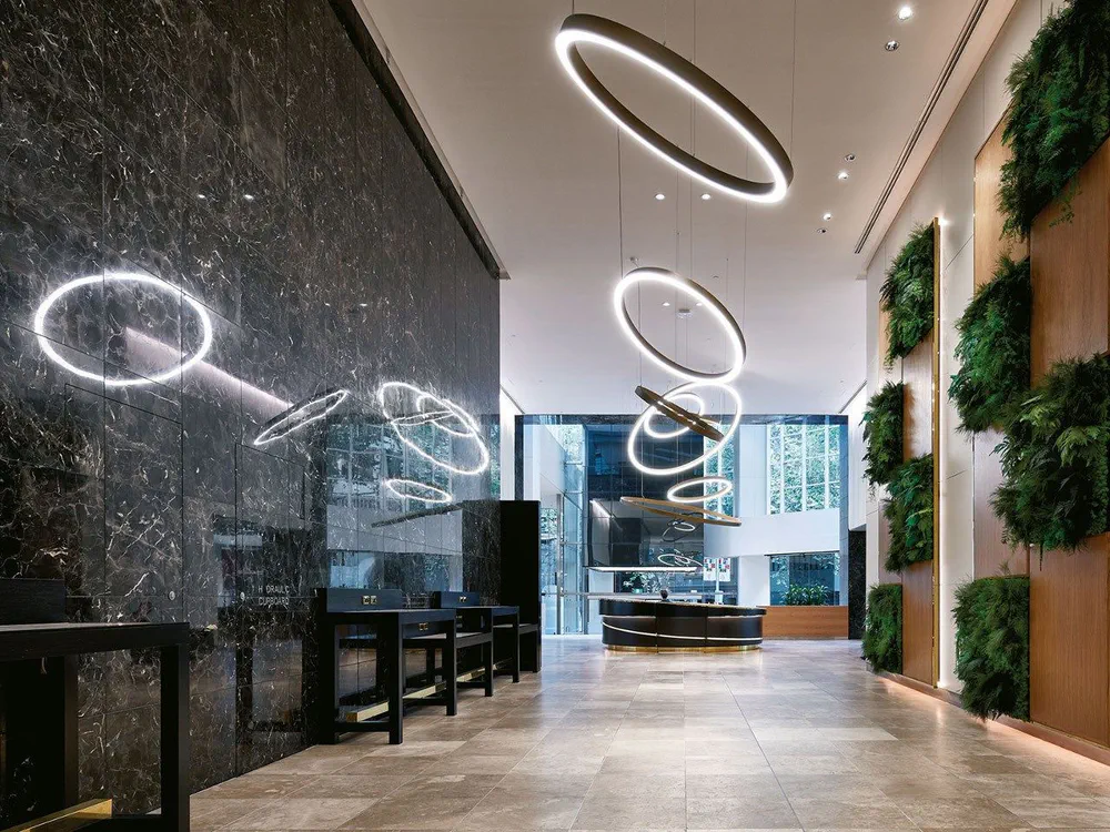 Modern Lobby Design with Circular Pendant Lights and Marble Wall
