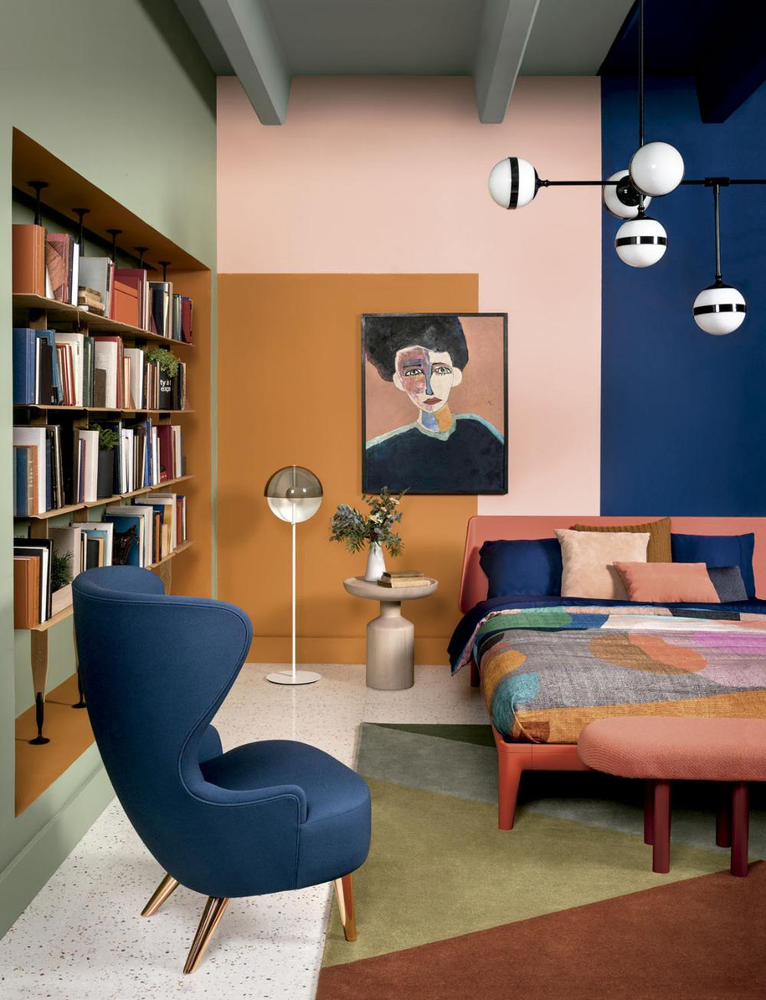 Modern Bedroom Design with Deep Blue Walls and Palm Leaf Pillows